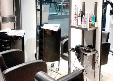 Chic salon interior at B-Bar Hair & Nails in Pafos, Baf, CY featuring modern black chairs and styling tools.