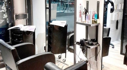 Chic salon interior at B-Bar Hair & Nails in Pafos, Baf, CY featuring modern black chairs and styling tools.