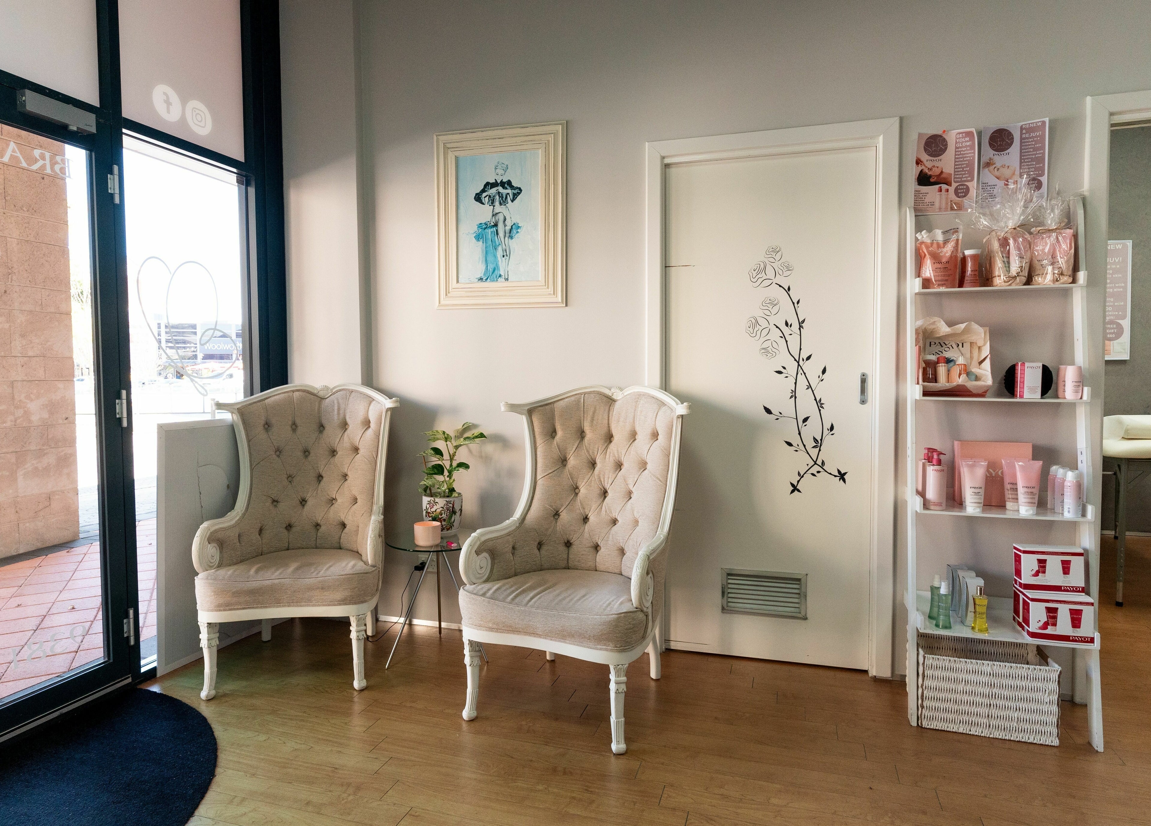 Elegant waiting area at Strip Womens Waxing Clinic, Subiaco, Western Australia, AU, featuring stylish chairs and products.