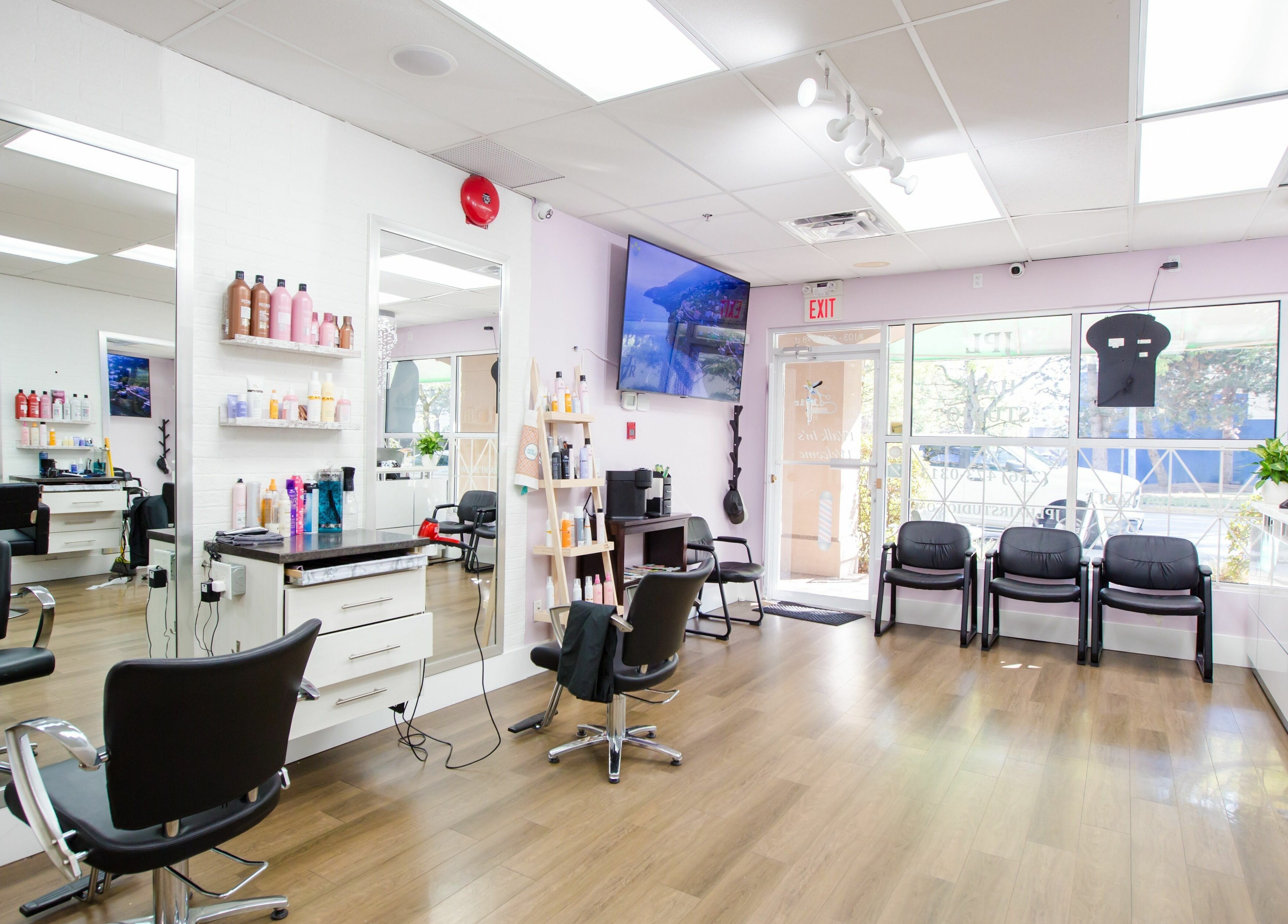 Modern interior of JPL Hair Studio in Langley, British Columbia, CA with salon chairs and hair products.
