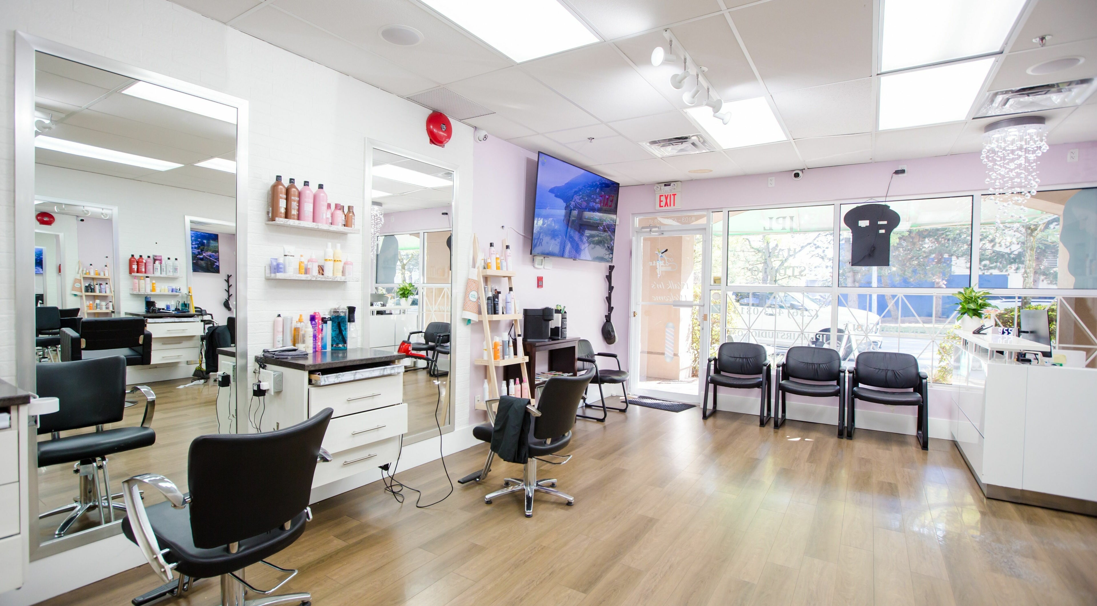 Modern interior of JPL Hair Studio in Langley, British Columbia, CA with salon chairs and hair products.