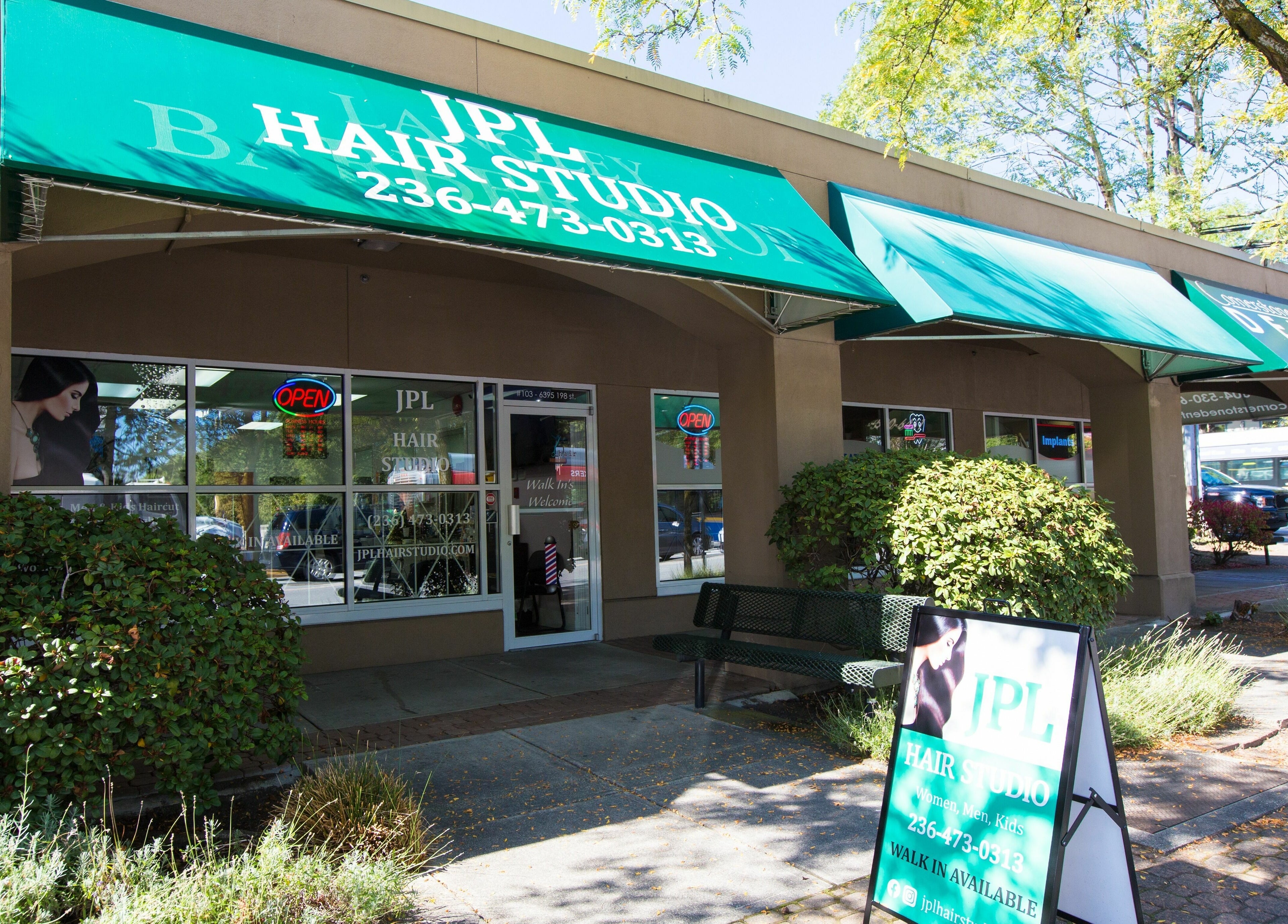 Exterior of JPL Hair Studio in Langley, BC showcasing green awning and welcoming entrance.
