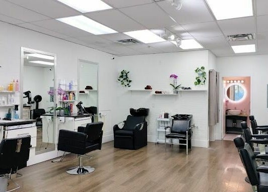 JPL Hair Studio's modern salon interior in Langley, British Columbia, CA, featuring stylish chairs and mirrors.