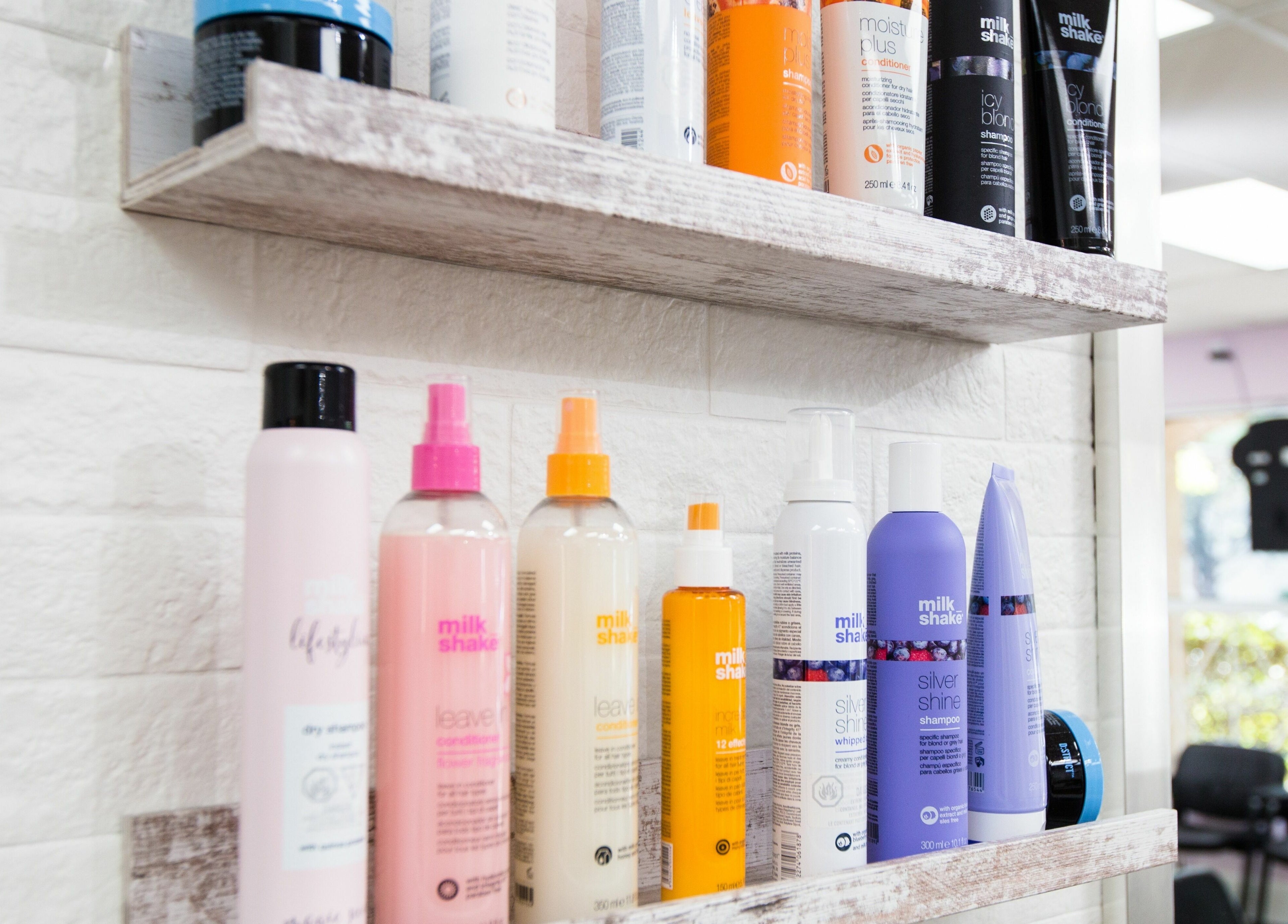 Colorful haircare products displayed at JPL Hair Studio in Langley, British Columbia, CA. Modern salon setting.