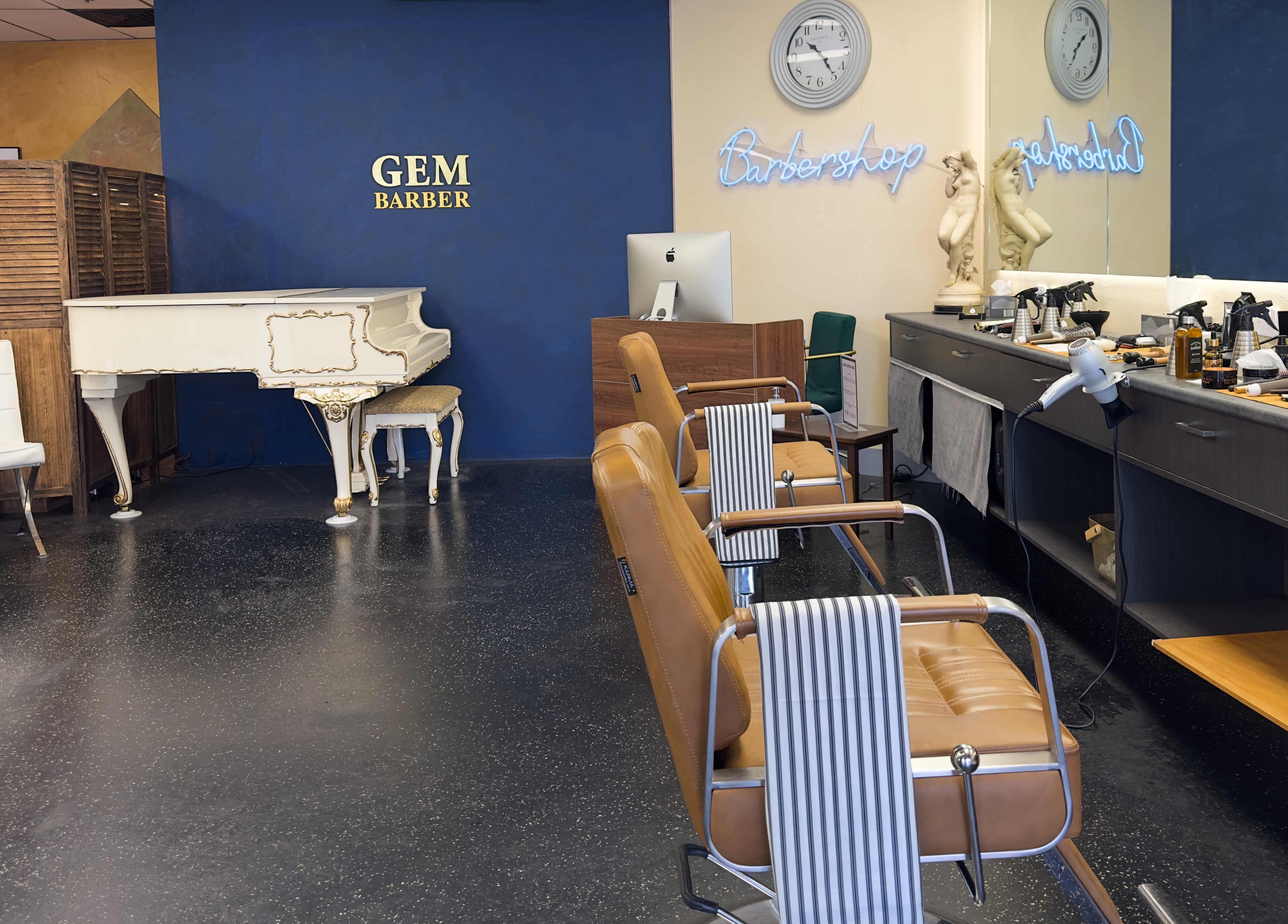 Interior of Gem Barber in Canberra with luxury styling chairs and vintage piano.