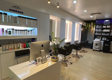 Modern salon interior at Topcurls Salon, Singapore, showcasing styling chairs and hair products.