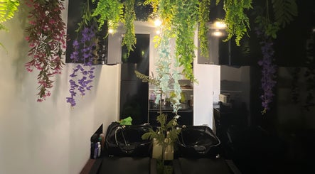 Hanging greenery at Topcurls Salon, a serene beauty space in Singapore, Singapore, SG with elegant decor.