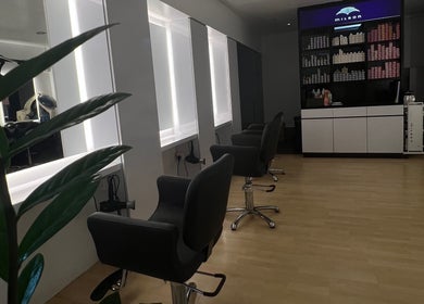 Stylish interior of Topcurls Salon in Singapore, SG, featuring modern salon chairs and sleek design.