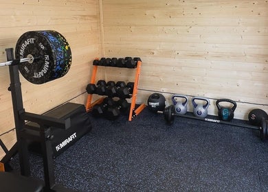 Gym corner with weights and bench at The Strength Studio & Sports Massage, Eastleigh, England, GB.