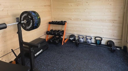 Gym corner with weights and bench at The Strength Studio & Sports Massage, Eastleigh, England, GB.