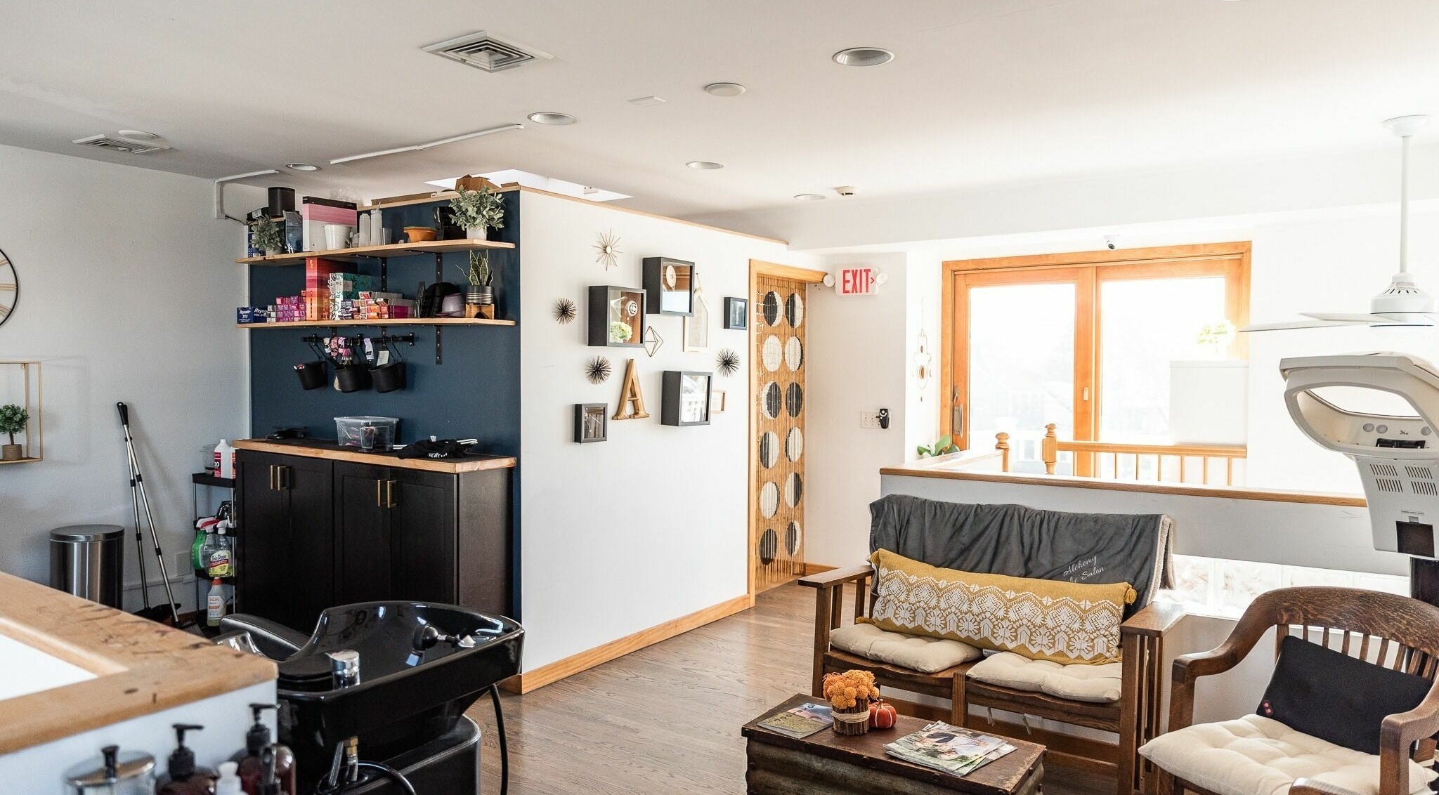Inviting interior of Alchemy, the Salon in Fairfield, Connecticut, US, showcasing stylish seating and decor.