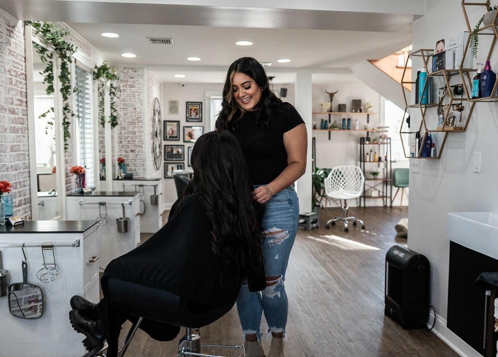 Stylist working with a client in Alchemy, the Salon, Fairfield, Connecticut, US, featuring chic decor.
