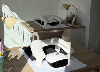 Nail station setup at Miracles Beauty Salon, Brighouse, England, GB, with lamps and manicure tools.