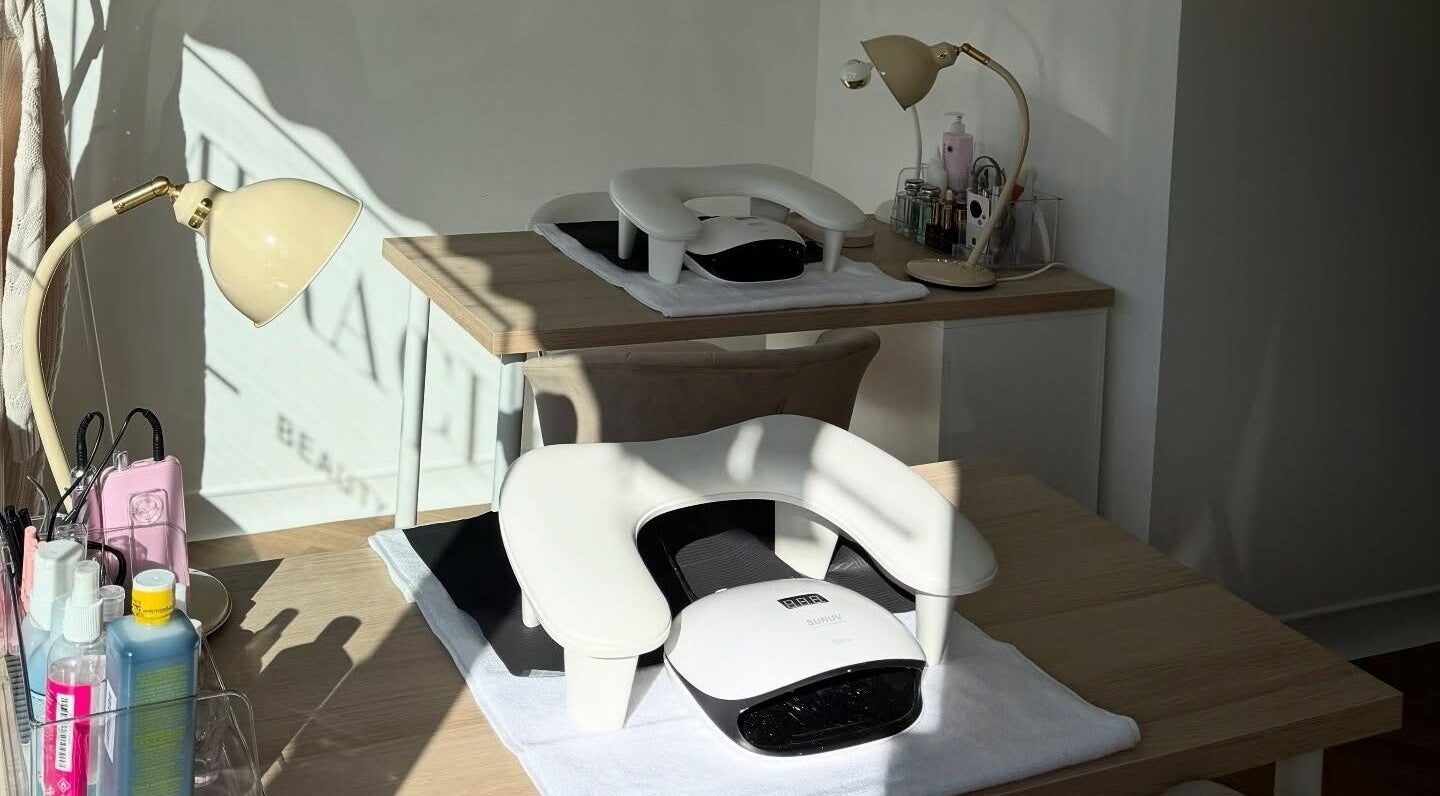 Nail station setup at Miracles Beauty Salon, Brighouse, England, GB, with lamps and manicure tools.