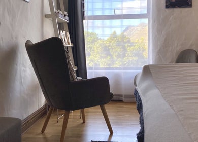Cozy chair by window in Christie's Wellness Room - Medical Massage Therapy, Cape Town, Western Cape, ZA.