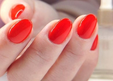 Close-up of vibrant red manicured nails at Studio 59, Rumney, Wales, GB.