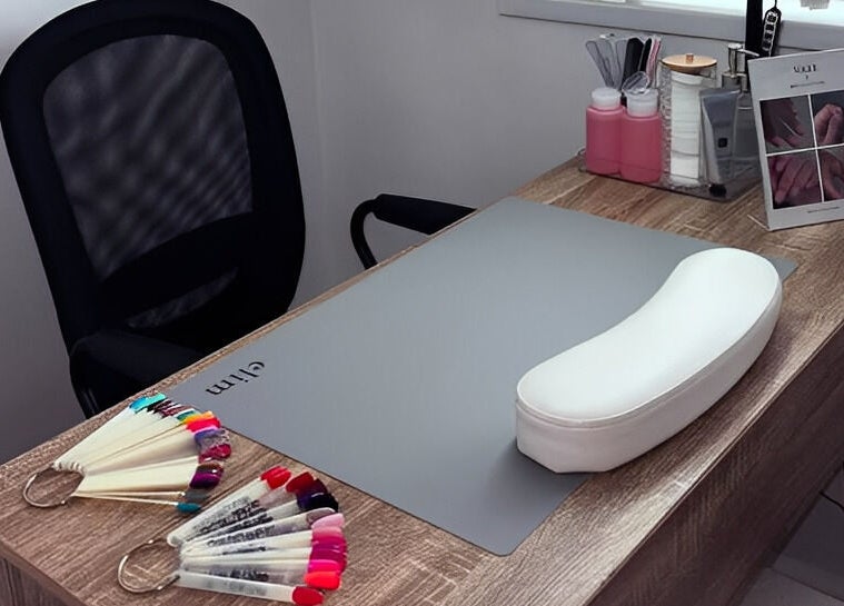 Nail art setup at Studio 59 Pro Cosmetology, Microblading & Body Piercing, Rumney, Wales, GB, showcasing tools and a desk.