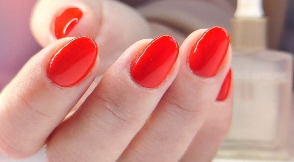 Bright red manicure at Studio 59 Pro Cosmetology, Microblading & Body Piercing, Rumney, Wales, GB.