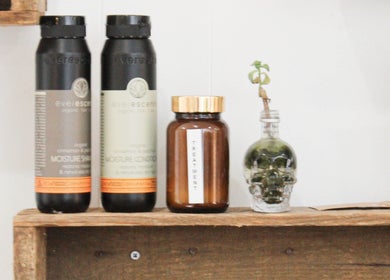 Organic hair products on a rustic shelf at Cass at Marina Drive, Shell Cove, New South Wales, AU.