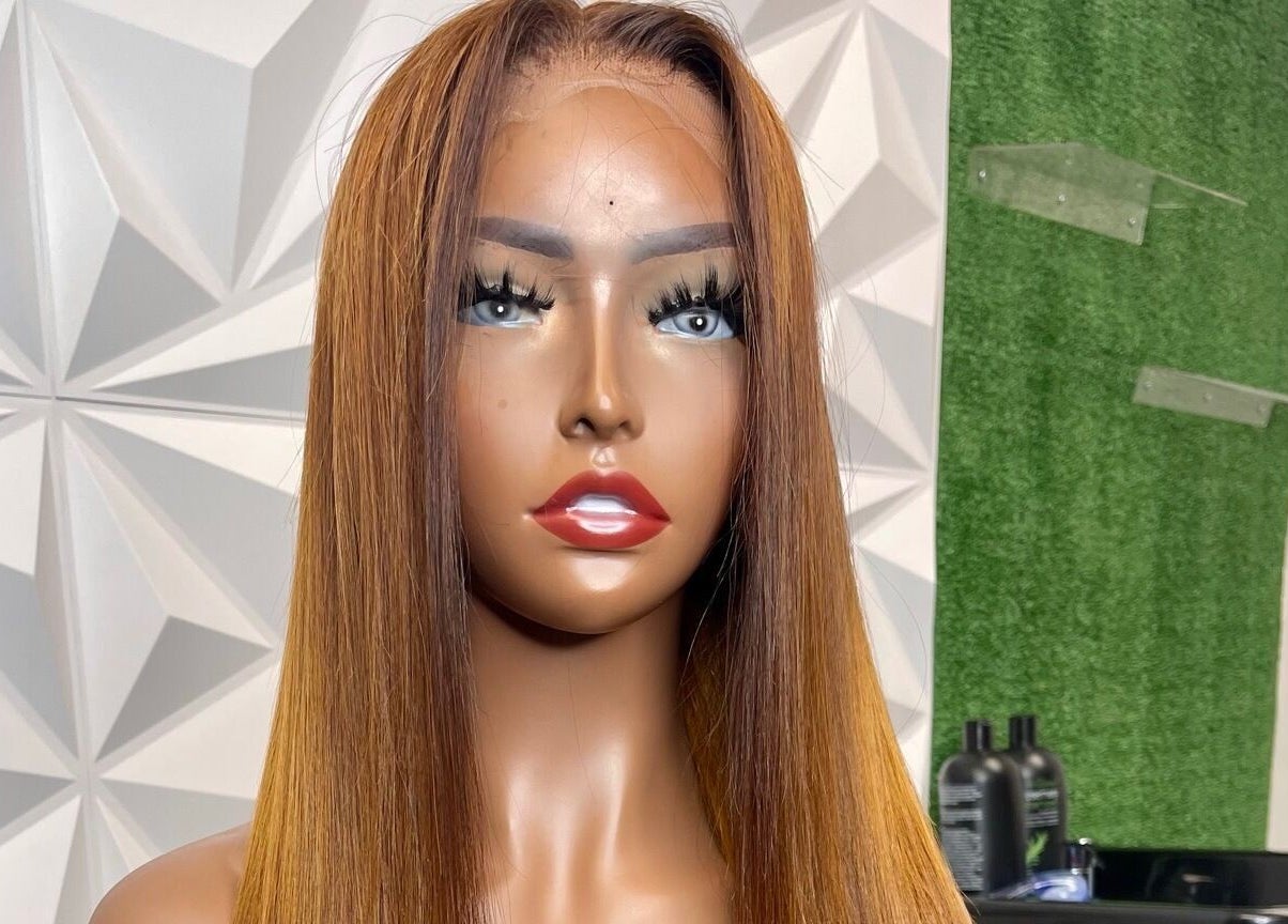 Lifelike mannequin showcasing a sleek, straight wig at The T Pearl Collection, Wilmington, Delaware, US.