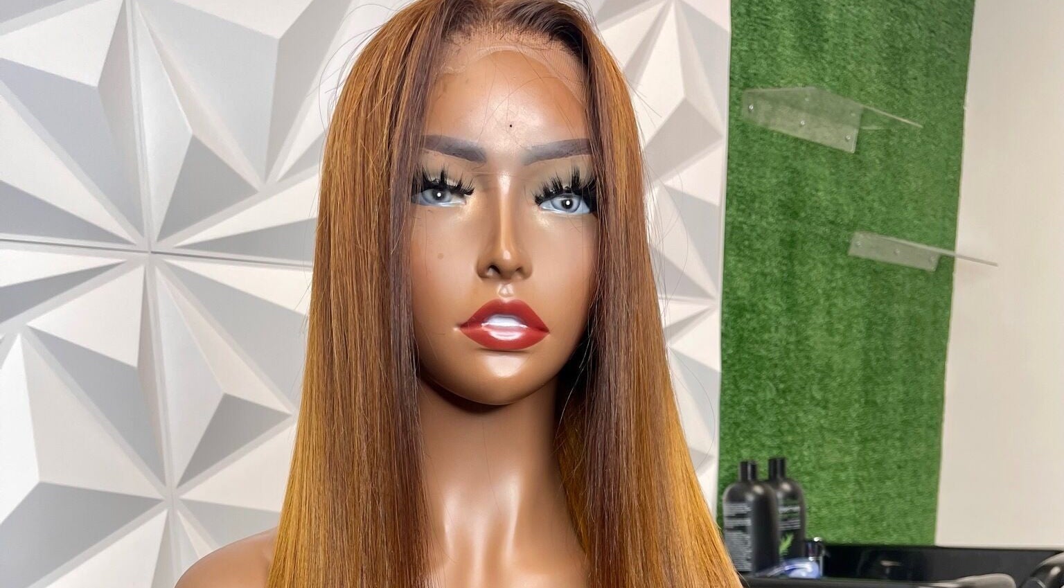 Lifelike mannequin showcasing a sleek, straight wig at The T Pearl Collection, Wilmington, Delaware, US.