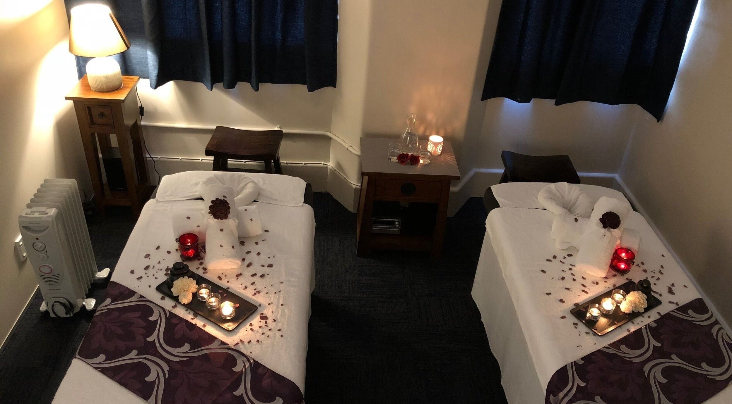 Relaxing massage room at Qubu Day Spa, Wellington, NZ, with cozy lighting and spa decor.