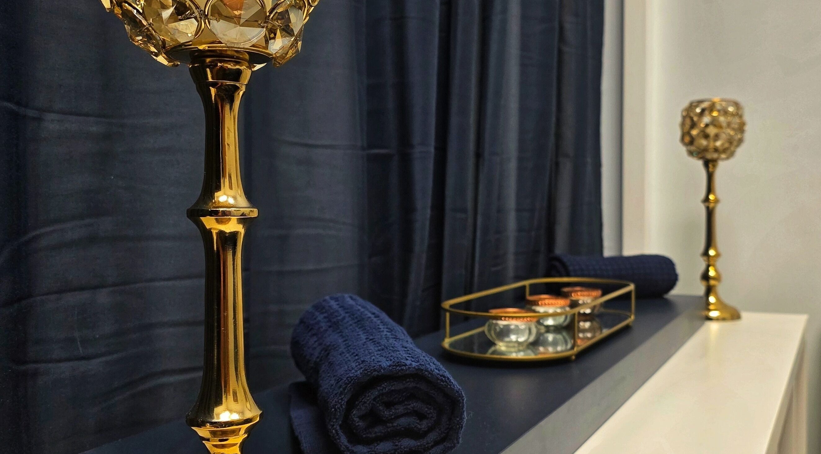 Luxurious gold candle holders and navy towels at Abbey Mill, Mile End Mill 12 Seedhill Road, Paisley, PA1 1JS, Paisley, Scotland, GB.