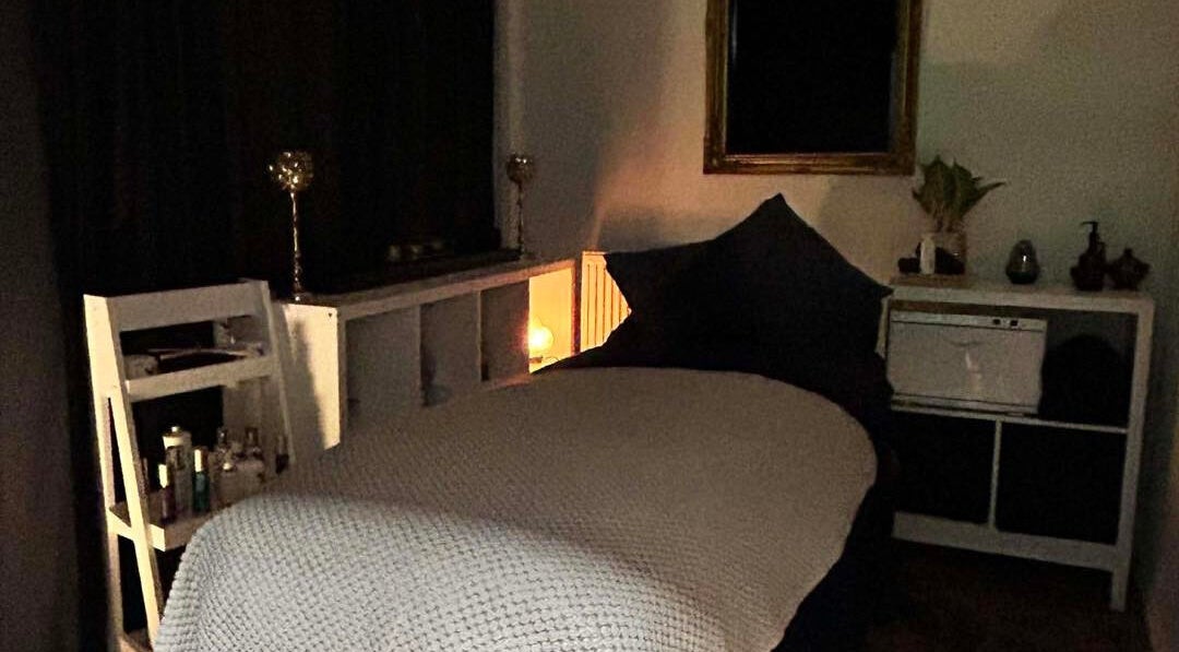 Cozy treatment room at Abbey Mill, Paisley, Scotland, GB with ambient lighting and spa bed.