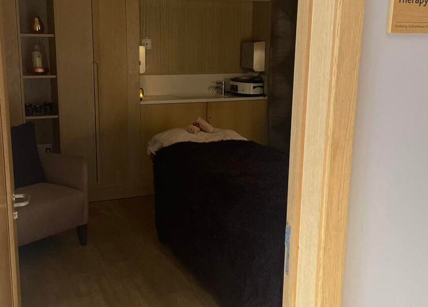 Cozy therapy room at Abbey Mill, Paisley, Scotland, GB with a massage table and warm decor.