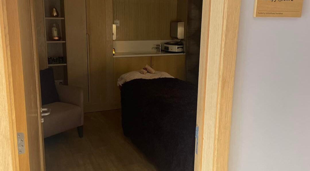 Cozy therapy room at Abbey Mill, Paisley, Scotland, GB with a massage table and warm decor.