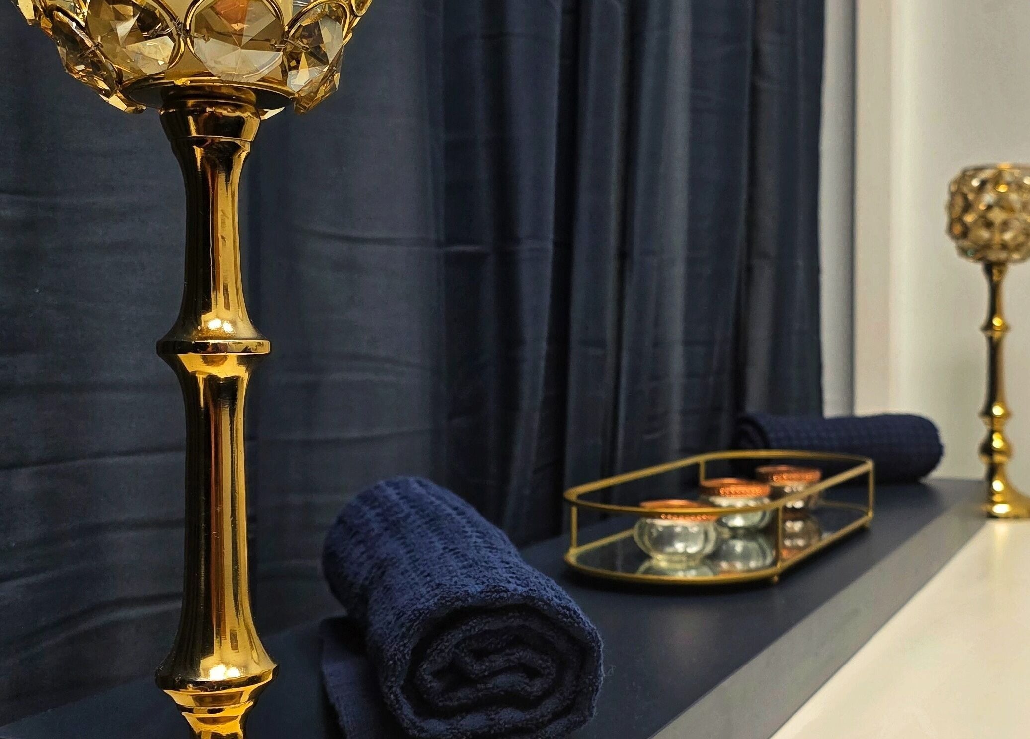 Elegant candleholders and luxury towels at Abbey Mill, Paisley, Scotland, GB enhance a tranquil spa atmosphere.