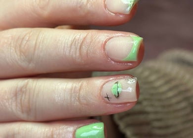 Stylish green manicure at LilyBeautyandNails in Burton-on-trent, England, GB with intricate nail art.