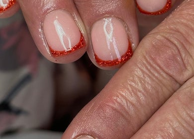 Red glitter nail tips at LilyBeautyandNails, Burton-on-trent, England, GB. Perfectly polished for a luxurious finish.
