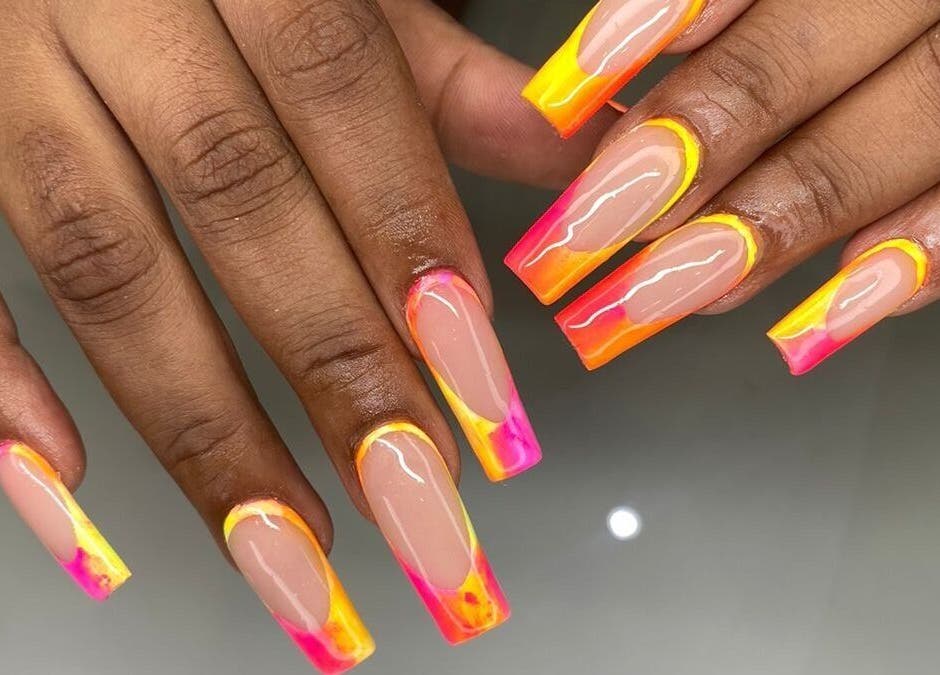 Colorful acrylic nails at Nails by Sam Potch in Potchefstroom, South Africa, ZA. Bright pink, orange, and yellow design.