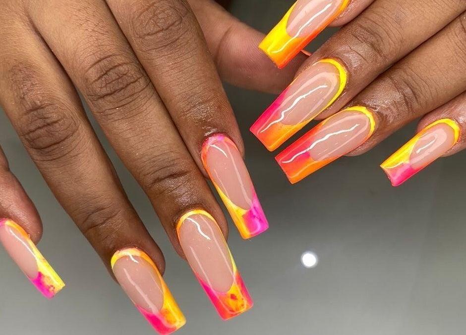 Colorful acrylic nails at Nails by Sam Potch in Potchefstroom, South Africa, ZA. Bright pink, orange, and yellow design.