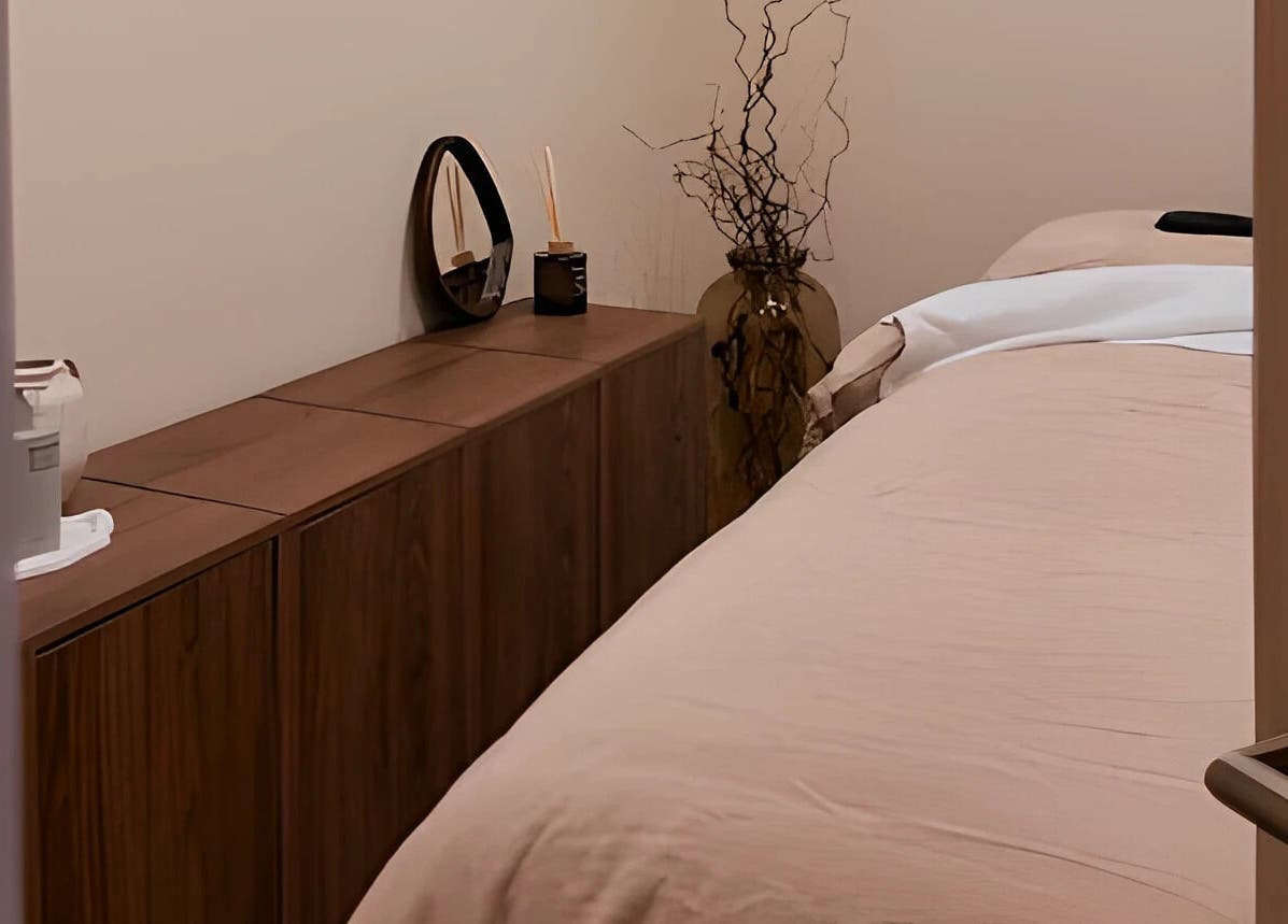 Cozy treatment room at By Jasmine Rose P, Longwell Green, England, GB, with a neatly made bed and elegant decor.