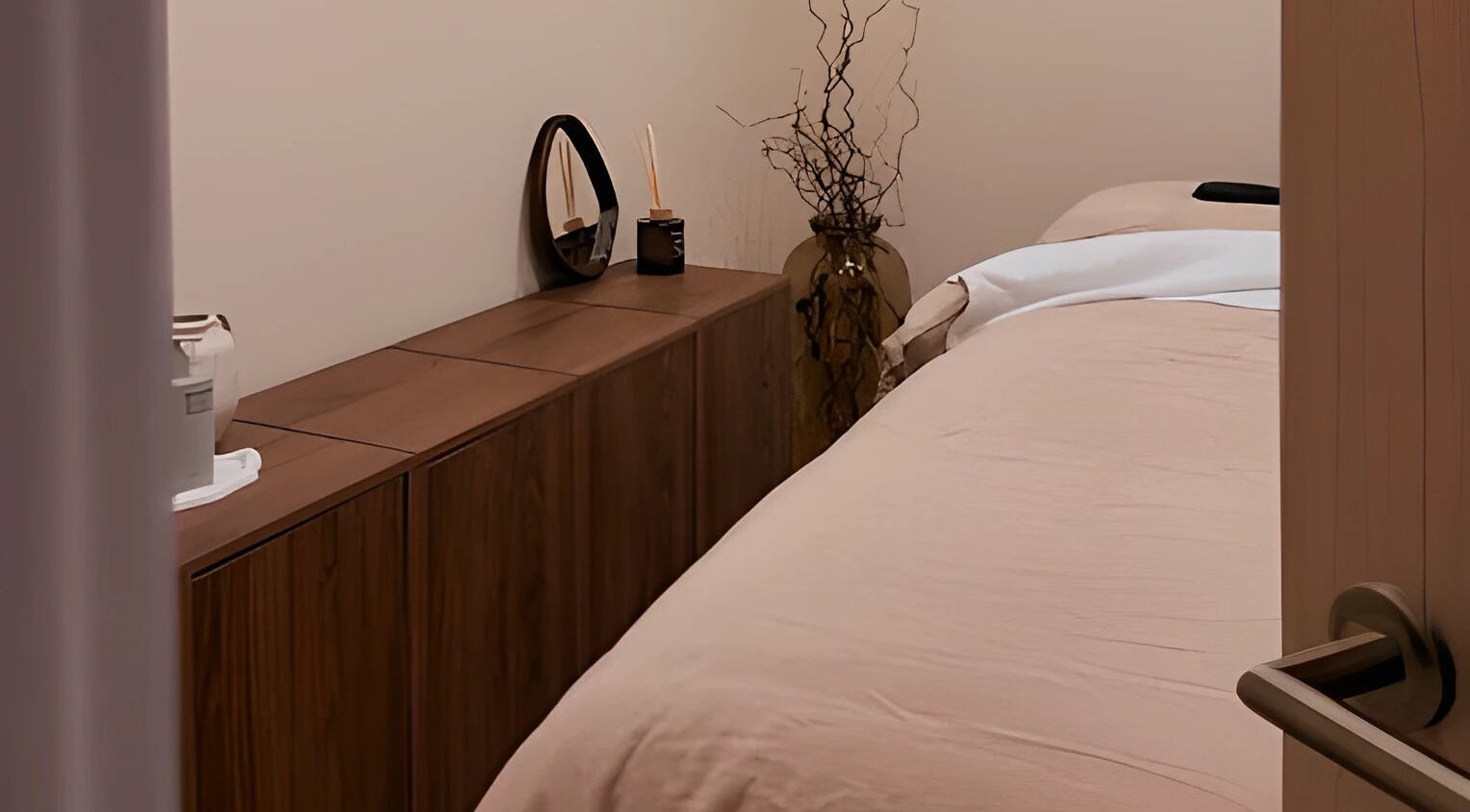 Cozy treatment room at By Jasmine Rose P, Longwell Green, England, GB, with a neatly made bed and elegant decor.