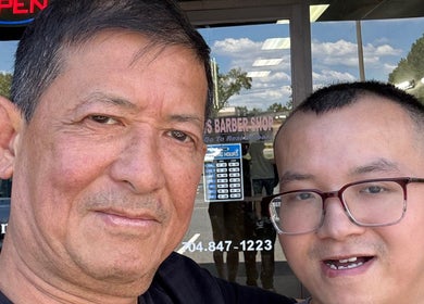 Smiling duo outside Matthews Barber Shop and Salon in Matthews, North Carolina, US, showcasing a welcoming vibe.