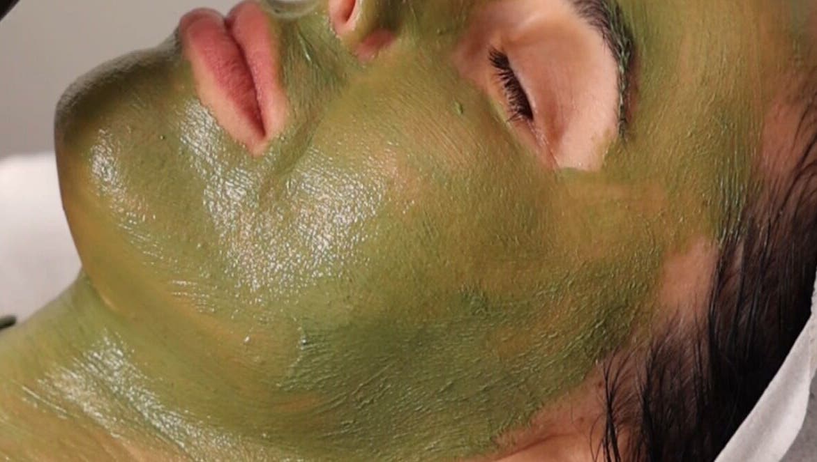 Relaxing facial with green mask at Fresh Faced Aesthetics, San Diego, California, US for glowing skin.
