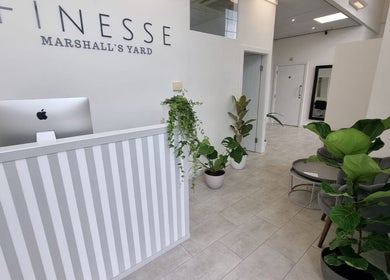 Reception area of Aesthetics by Hannah in Gainsborough, England featuring modern decor and lush plants.