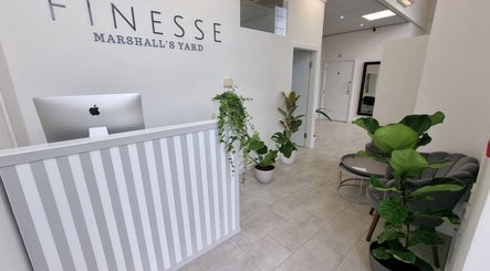 Reception area of Aesthetics by Hannah in Gainsborough, England featuring modern decor and lush plants.