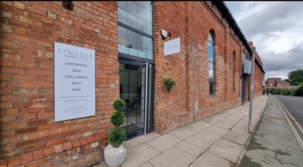 Chic brick façade of Aesthetics by Hannah in Gainsborough, England, GB featuring modern glass doors.