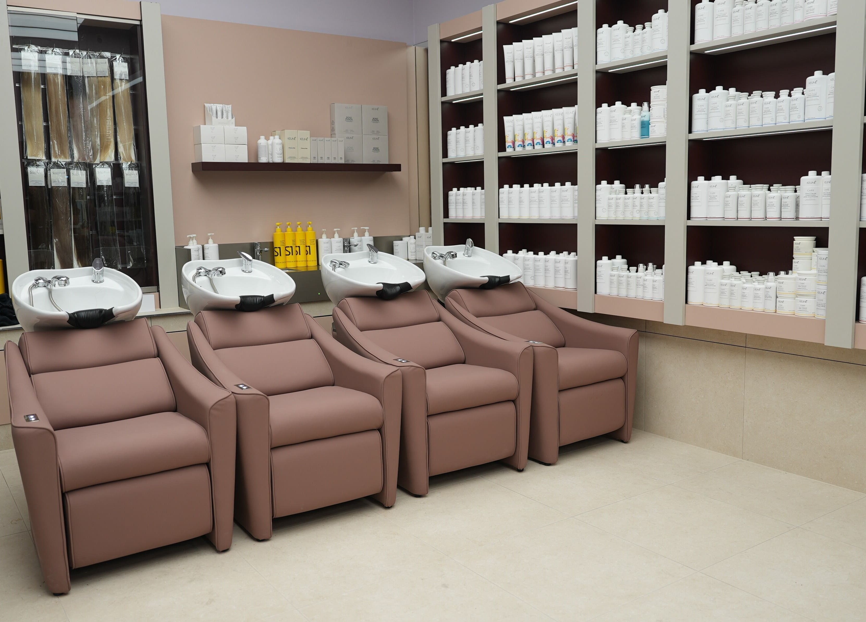 Luxury wash station at W Hair Bar, Eastgardens, New South Wales, AU surrounded by product shelves.