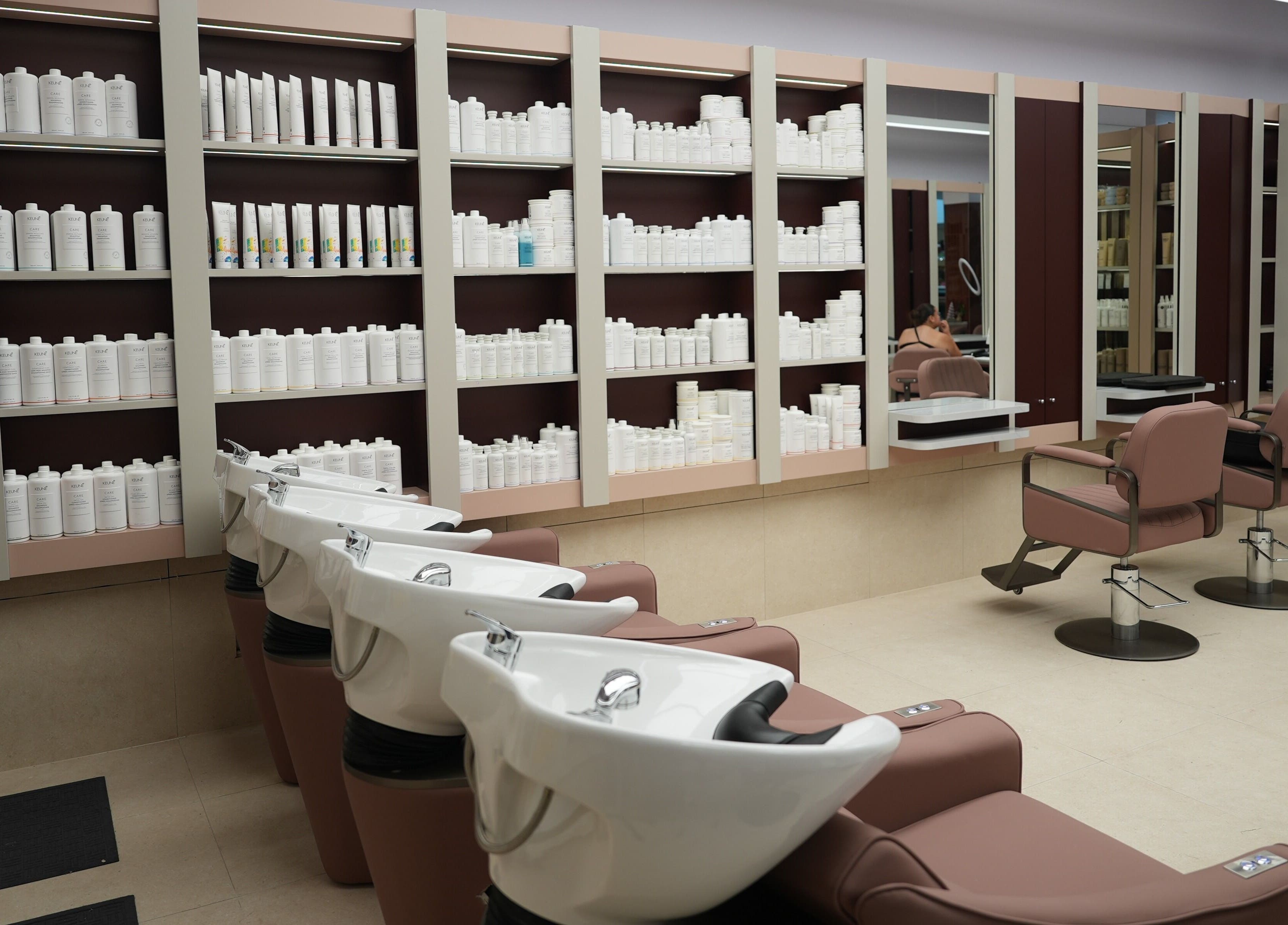 W Hair Bar - East Garden salon interior with sleek chairs and product shelves in Eastgardens, New South Wales, AU.