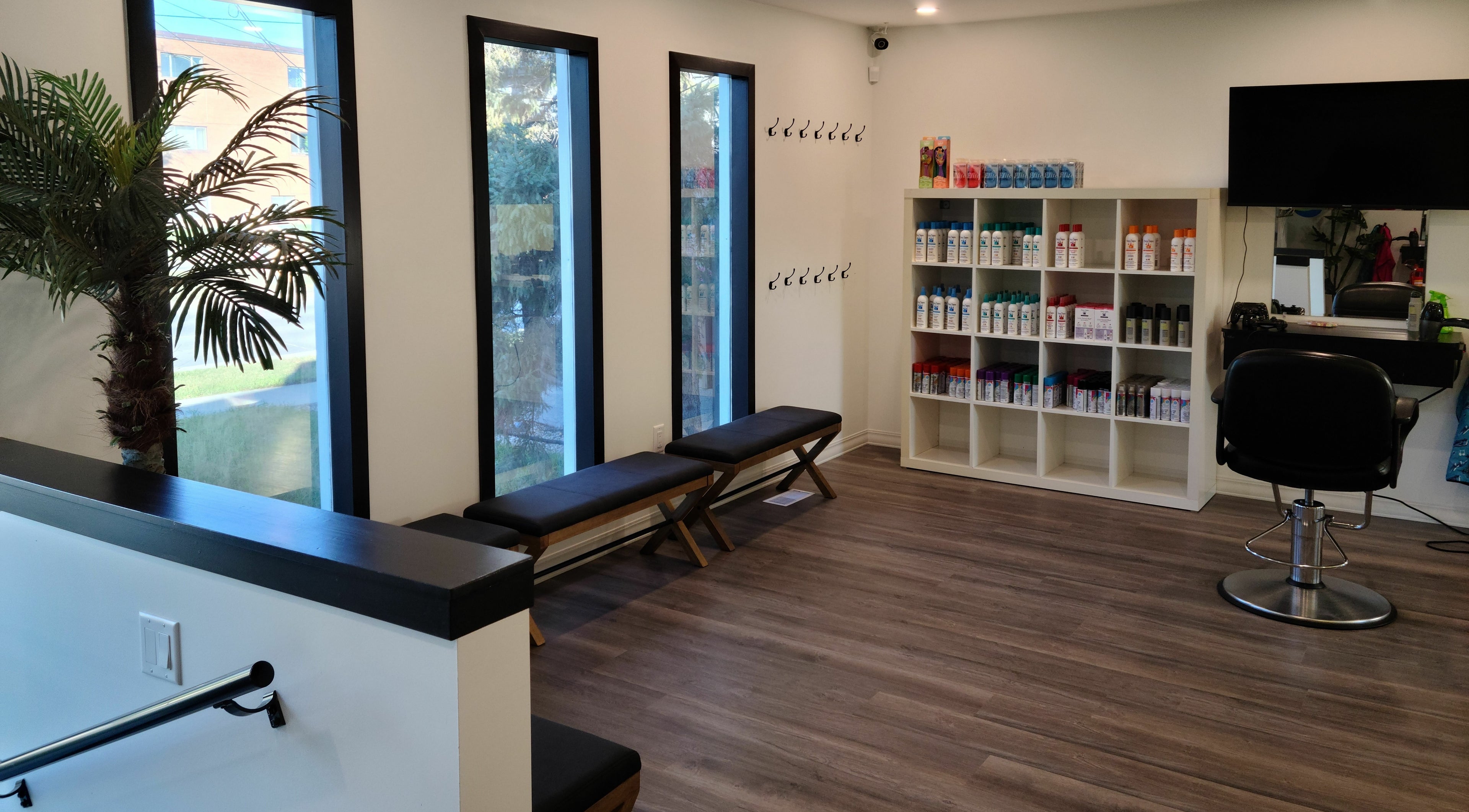 Modern waiting area in Mane Tamers Salon For Kids, Winnipeg, Manitoba, CA with seating and hair products.