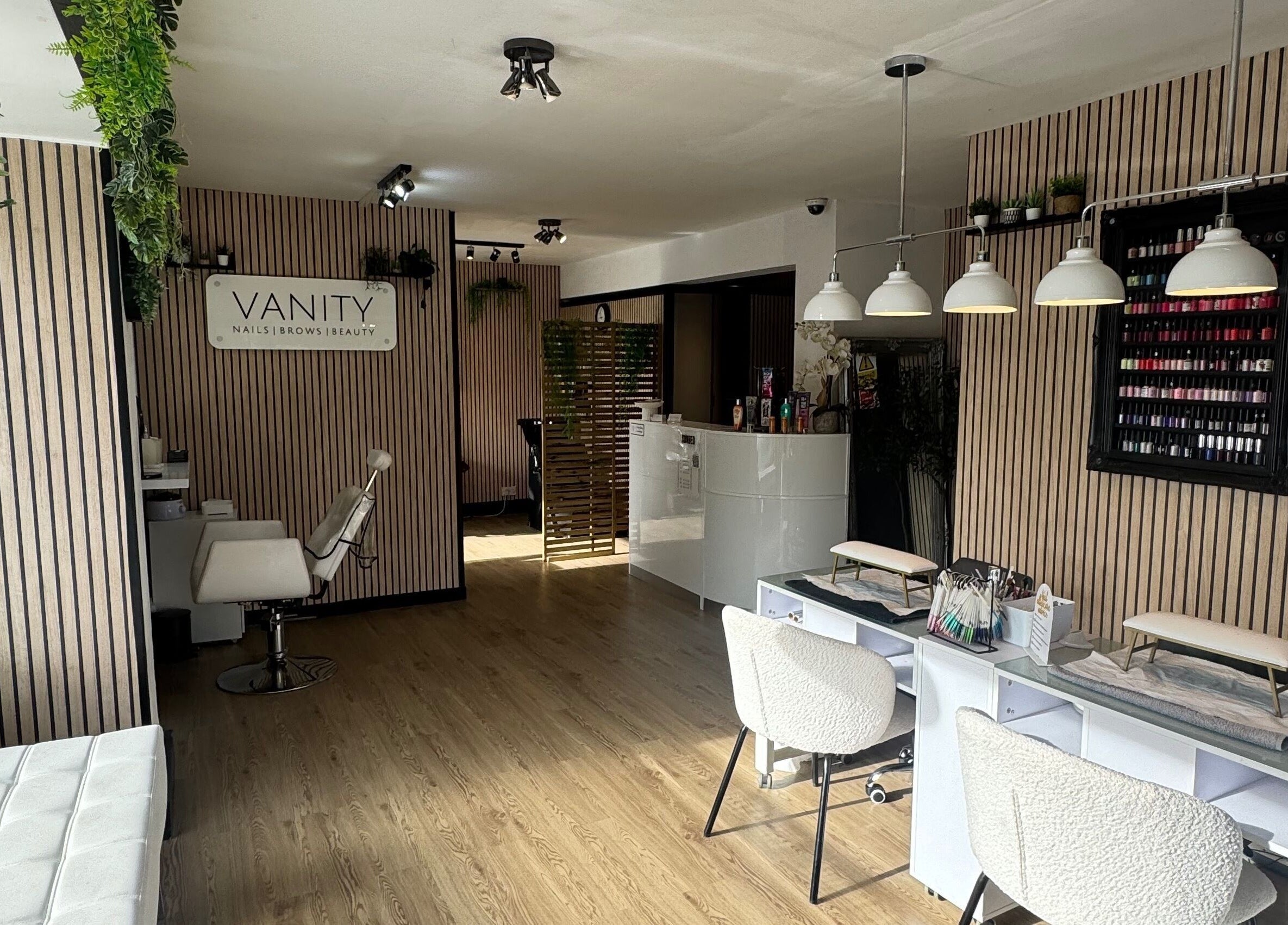 Chic interior of Vanity Beauty Naphill, High Wycombe, England, with nail stations and elegant decor.