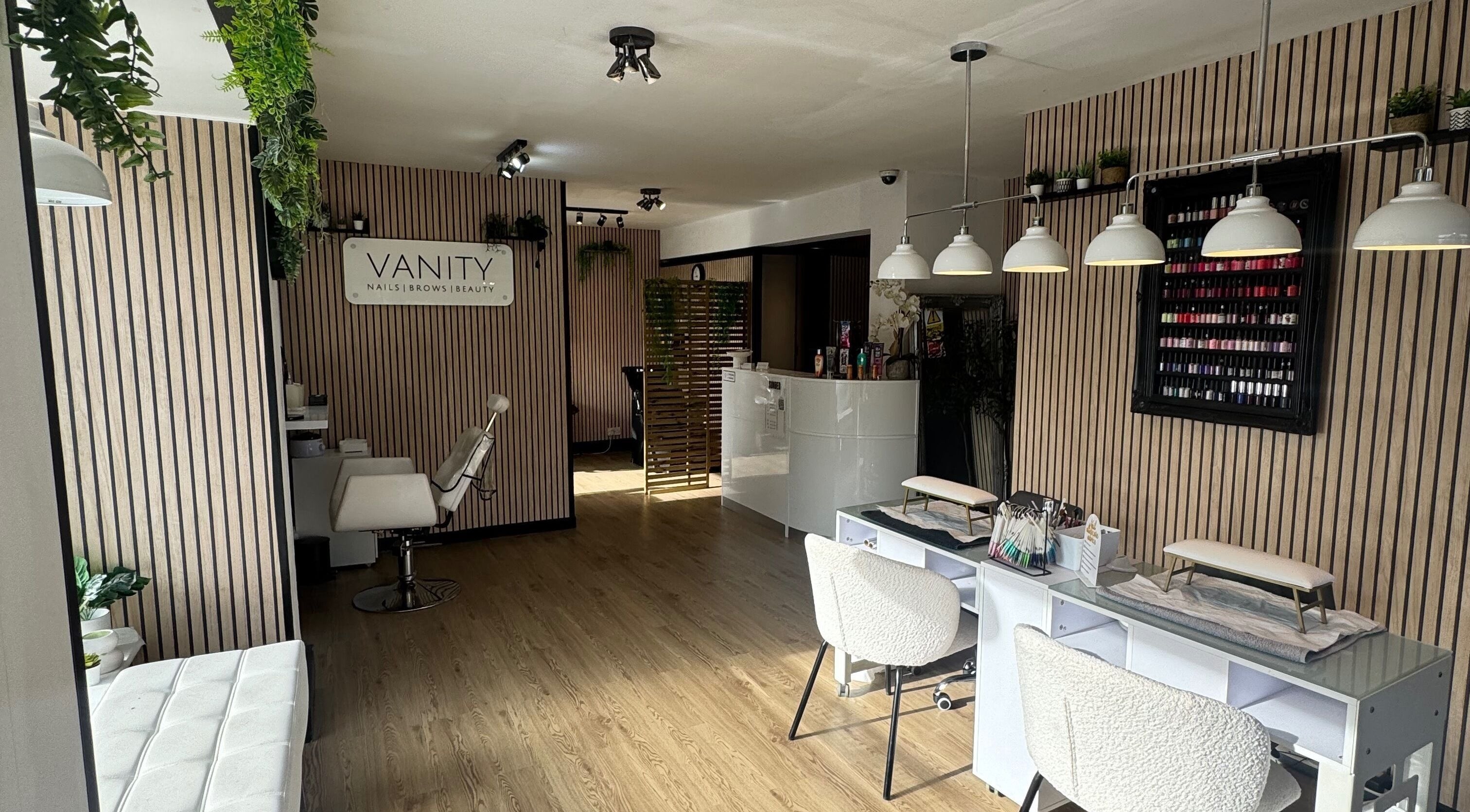 Chic interior of Vanity Beauty Naphill, High Wycombe, England, with nail stations and elegant decor.