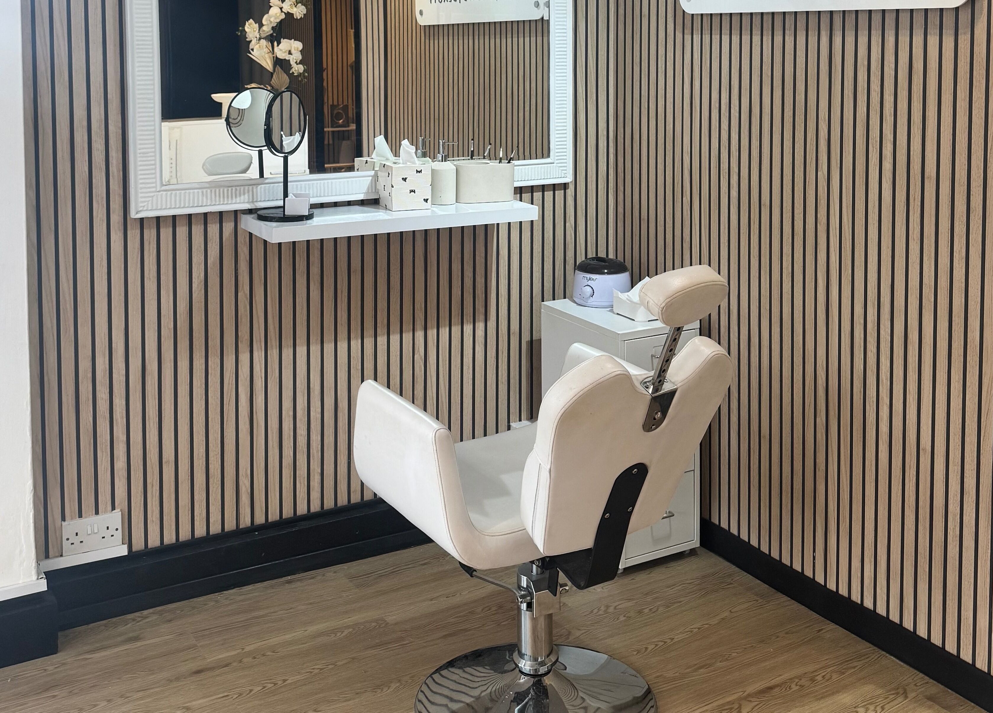 Modern hair salon chair at Vanity Beauty Naphill in High Wycombe, England. Elegant styling space.