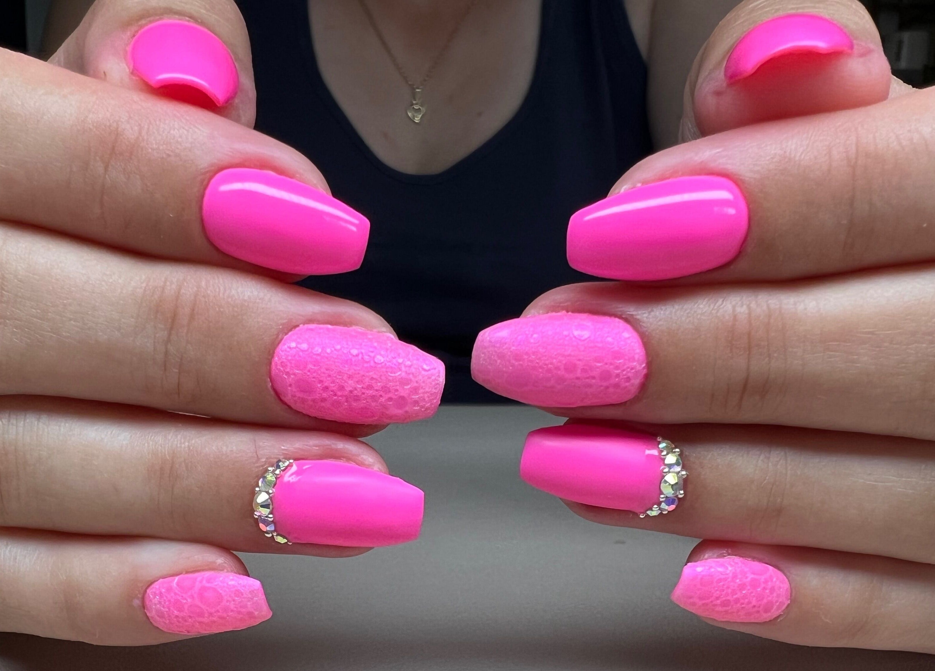 Vibrant pink gel nails with glitter design at Bon-Di Nails, Bristol, Anglia, GB.