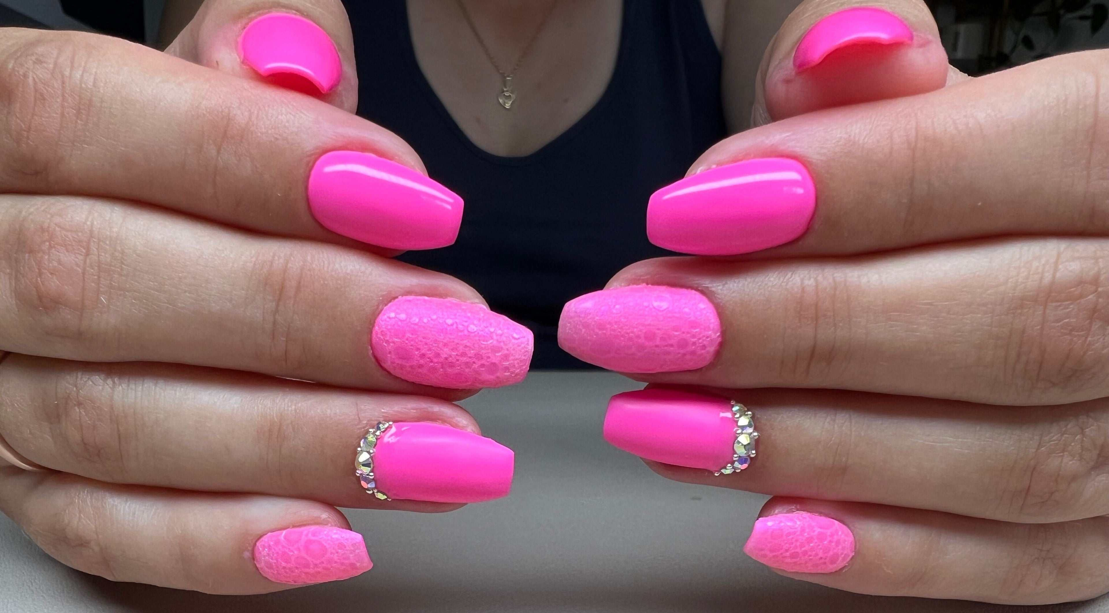 Vibrant pink gel nails with glitter design at Bon-Di Nails, Bristol, Anglia, GB.